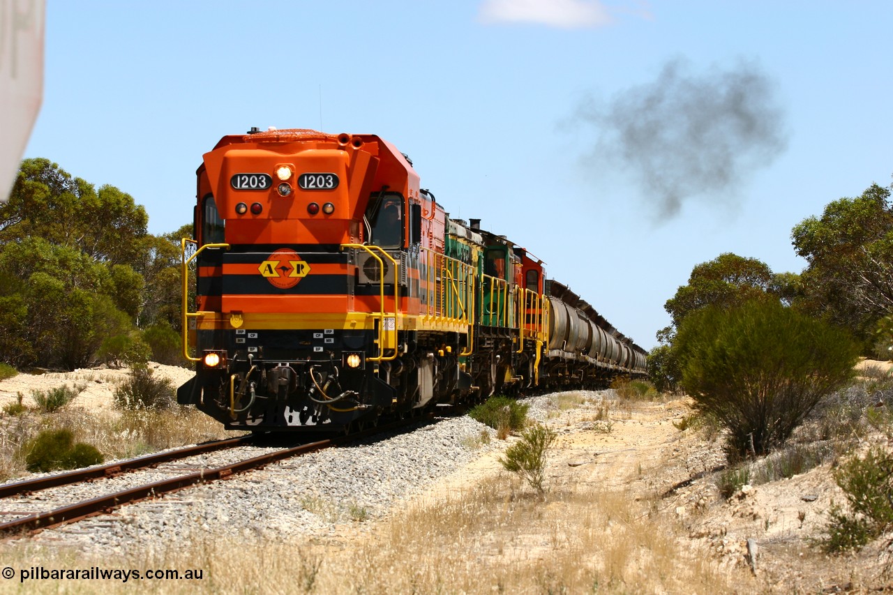 060111 2275
Peachna, Tooligie Hill Road grade crossing, empty grain train running north behind ARG 1200 class unit 1203, a Clyde Engineering EMD model G12C serial 65-427, one of fourteen originally built between 1960-65 for WAGR as their A class A 1513, fitted with dynamic brakes and financed by Western Mining Corporation, started working on the Eyre Peninsula in November 2004. 11th January 2006.
Keywords: 1200-class;1203;Clyde-Engineering-Granville-NSW;EMD;G12C;65-427;A-class;A1513;