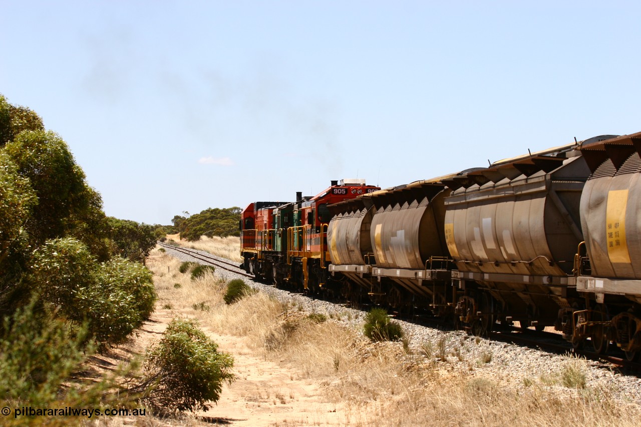 060111 2276
Peachna, Tooligie Hill Road grade crossing, empty grain train running north behind ARG 1200 class unit 1203, a Clyde Engineering EMD model G12C serial 65-427, one of fourteen originally built between 1960-65 for WAGR as their A class A 1513, fitted with dynamic brakes and financed by Western Mining Corporation, started working on the Eyre Peninsula in November 2004. 11th January 2006.
