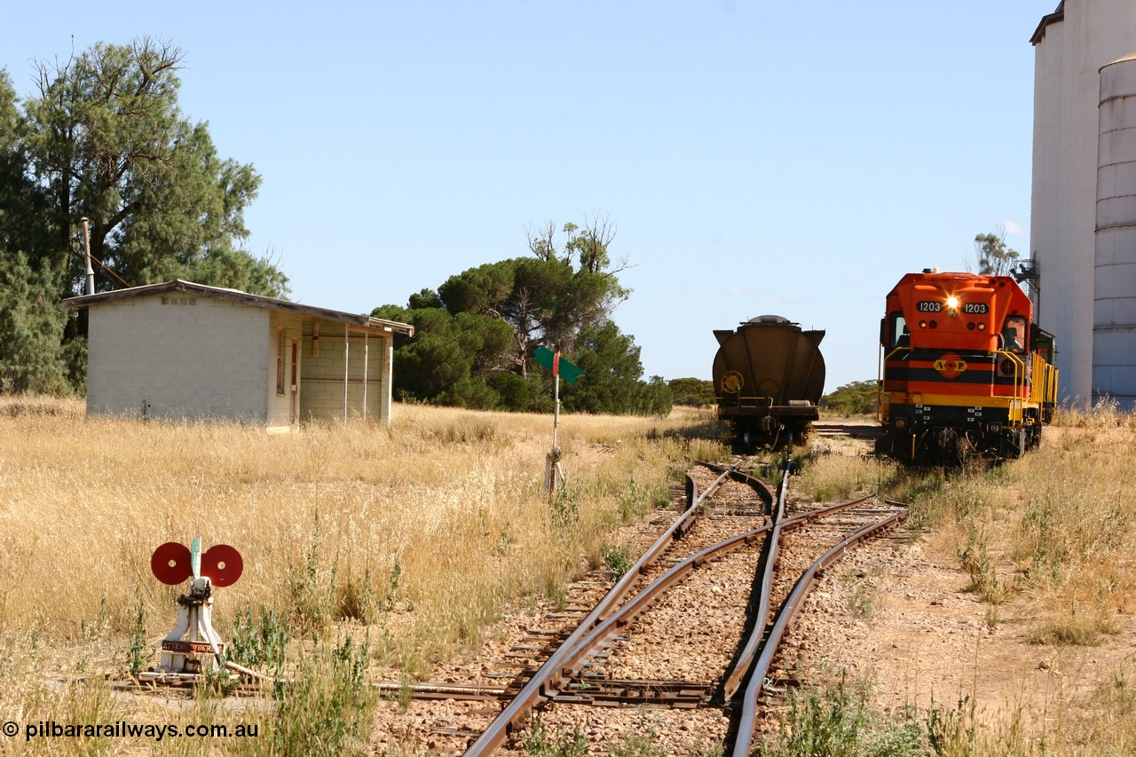 060111 2323
Warramboo, located at the 190.2 km and opened with the line in May 1913, with now disused station building on the left, Clyde Engineering built EMD G12C model loco 1203 serial 65-427 shunts empty grain waggons into the grain loop for loading. 11th January 2006.
Keywords: 1200-class;1203;Clyde-Engineering-Granville-NSW;EMD;G12C;65-427;A-class;A1513;