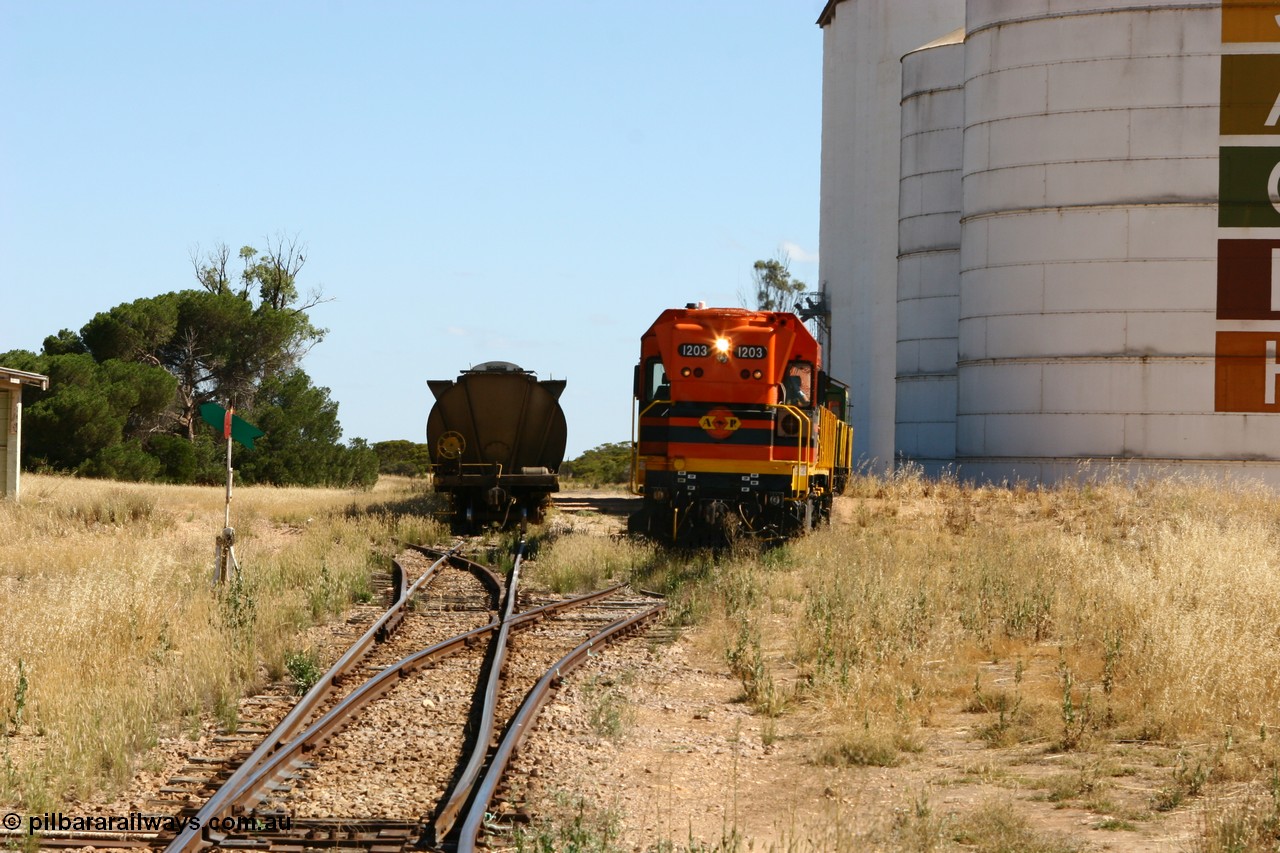 060111 2324
Warramboo, located at the 190.2 km with now disused station building on the left, Clyde Engineering built EMD G12C model loco 1203 serial 65-427 shunts empty grain waggons into the grain loop for loading. 11th January 2006.
Keywords: 1200-class;1203;Clyde-Engineering-Granville-NSW;EMD;G12C;65-427;A-class;A1513;