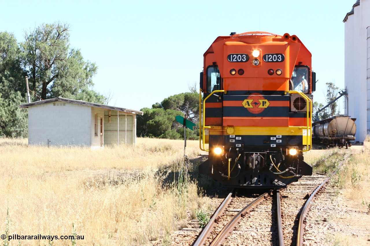 060111 2329
Warramboo, located at the 190.2 km and opened with the line in May 1913, with now disused station building on the left, Clyde Engineering built EMD G12C model loco 1203 serial 65-427 stands on the mainline as loading on the grain siding has started. 11th January 2006.
Keywords: 1200-class;1203;Clyde-Engineering-Granville-NSW;EMD;G12C;65-427;A-class;A1513;