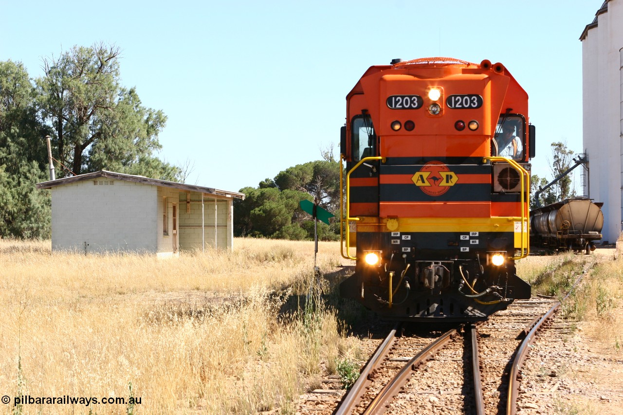 060111 2331
Warramboo, located at the 190.2 km and opened with the line in May 1913, with now disused station building on the left, Clyde Engineering built EMD G12C model loco 1203 serial 65-427 stands on the mainline as loading on the grain siding has started. 11th January 2006.
Keywords: 1200-class;1203;Clyde-Engineering-Granville-NSW;EMD;G12C;65-427;A-class;A1513;