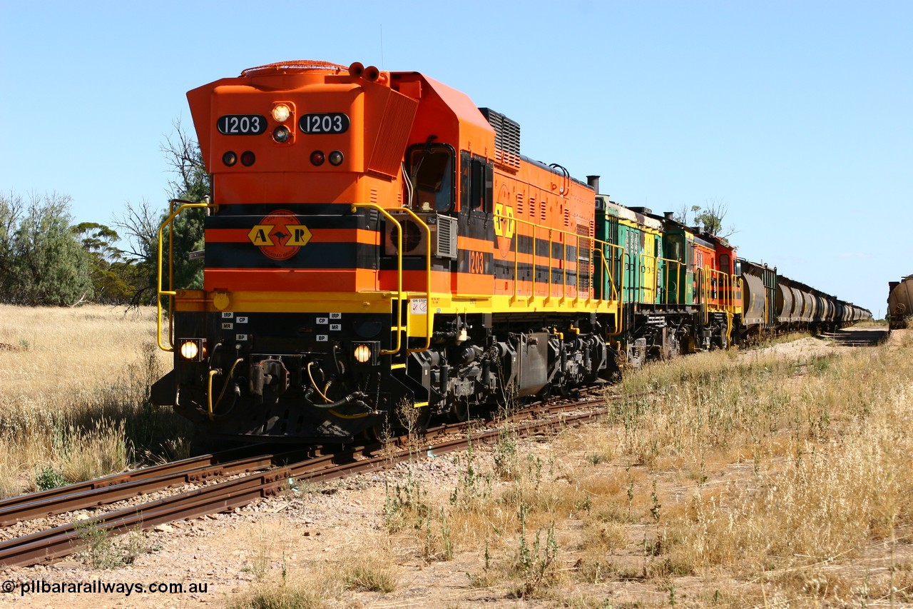 060111 2332
Warramboo, located at the 190.2 km and opened with the line in May 1913, with now disused station building on the left, Clyde Engineering built EMD G12C model loco 1203 serial 65-427 stands on the mainline as loading on the grain siding has started. 11th January 2006.
Keywords: 1200-class;1203;Clyde-Engineering-Granville-NSW;EMD;G12C;65-427;A-class;A1513;