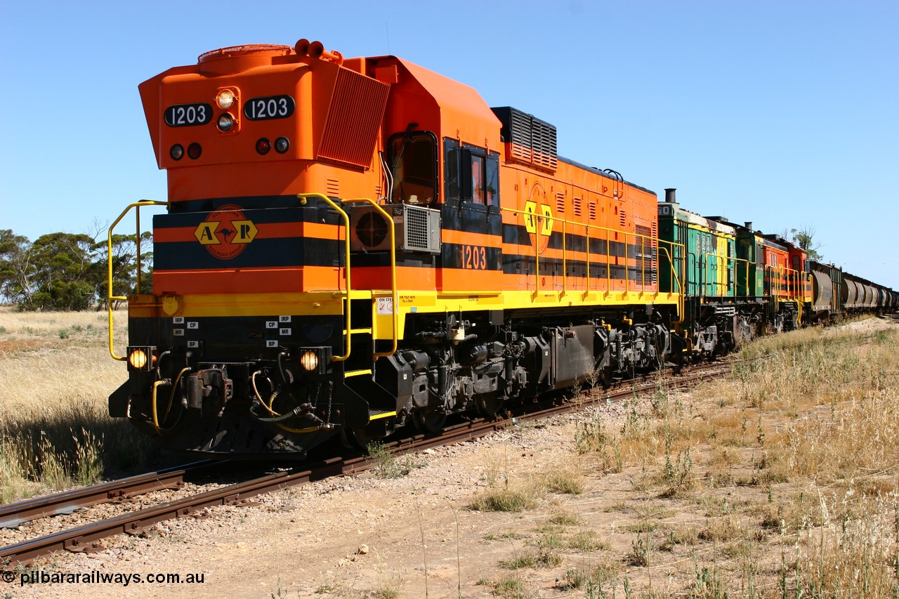 060111 2334
Warramboo, located at the 190.2 km and opened with the line in May 1913, with now disused station building on the left, Clyde Engineering built EMD G12C model loco 1203 serial 65-427 stands on the mainline as loading on the grain siding has started. 11th January 2006.
Keywords: 1200-class;1203;Clyde-Engineering-Granville-NSW;EMD;G12C;65-427;A-class;A1513;