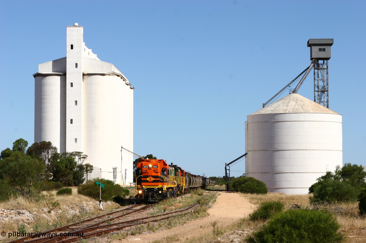 060111 2342
Kyancutta, the concrete and steel silo complexes frame ARG 1200 class unit 1203, a Clyde Engineering EMD model G12C serial 65-427, one of fourteen originally built between 1960-65 for WAGR as their A class A 1513, fitted with dynamic brakes and financed by Western Mining Corporation, started working on the Eyre Peninsula in November 2004 as it leads a north bound empty grain train. 11th January 2006.
Keywords: 1200-class;1203;Clyde-Engineering-Granville-NSW;EMD;G12C;65-427;A-class;A1513;