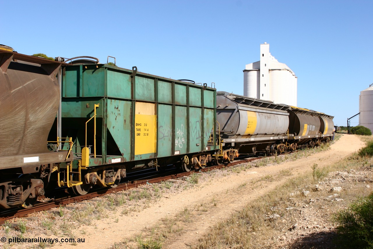 060111 2353
Kyancutta, this shot shows three of the types of waggon used, former Australian National narrow gauge ENHG type bogie grain waggon ENHG 3, originally built by Moore Road Ind, Victoria as NB type NB 1398 ballast hopper for the NAR, then to standard gauge in 1975 as BA type BA 1540, recoded to AHTY in 1980, to EP April 1984, recoded to NHG type NHG 6 in May 1984, then again to ENHT type ENHT 6 in March 1985 and further rebuilt forming one half of ENHG type grain waggon in August 1986. The conversion involved splicing two AHTY-ENHT type waggons together at Port Lincoln workshops, an HCN type HCN 4, was modified at Islington Workshops in 1978-80 and started life as a Tulloch built NHB type iron ore hopper for the CR on the North Australia Railway in 1968-69, and an SAR built HAN type as they are shunted back into the grain siding for loading. 11th January 2006.
Keywords: ENHG-type;ENHG3;Moore-Road-Ind-Victoria;NB-type;NB1398;BA-type;BA1540;AHTY-type;NHG-type;NHG6;ENHT-type;