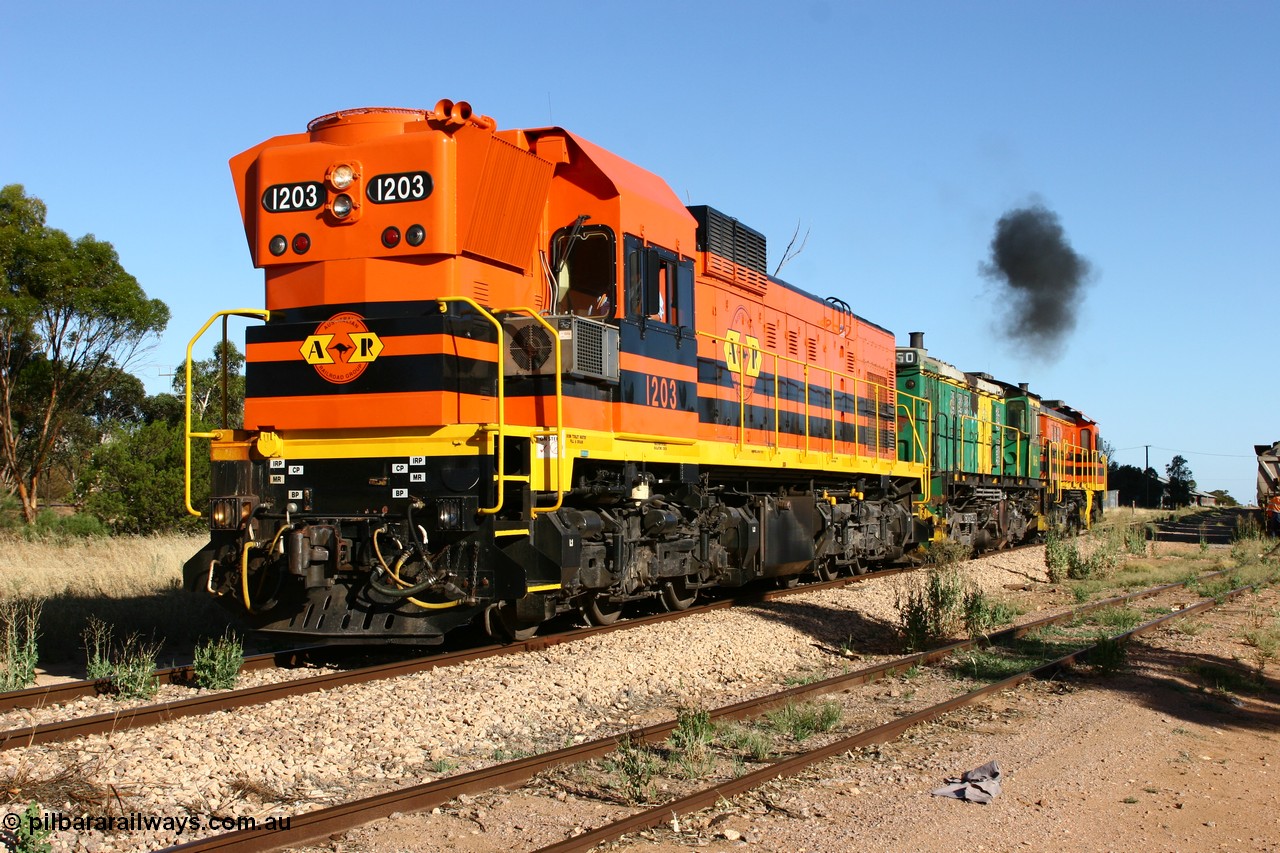 060111 2410
Wudinna, ARG 1200 class unit 1203, a Clyde Engineering EMD model G12C serial 65-427, one of fourteen originally built between 1960-65 for WAGR as their A class A 1513, fitted with dynamic brakes and financed by Western Mining Corporation, started working on the Eyre Peninsula in November 2004, 1203 and two ALCo units 850 and 905 shunt back down the mainline at Wudinna as they run round their consist. 11th January 2006.
Keywords: 1200-class;1203;Clyde-Engineering-Granville-NSW;EMD;G12C;65-427;A-class;A1513;