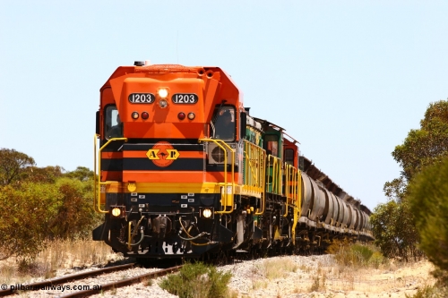 060111 2273
Peachna, Tooligie Hill Road grade crossing, empty grain train running north behind ARG 1200 class unit 1203, a Clyde Engineering EMD model G12C serial 65-427, one of fourteen originally built between 1960-65 for WAGR as their A class A 1513, fitted with dynamic brakes and financed by Western Mining Corporation, started working on the Eyre Peninsula in November 2004. 11th January 2006.
Keywords: 1200-class;1203;Clyde-Engineering-Granville-NSW;EMD;G12C;65-427;A-class;A1513;