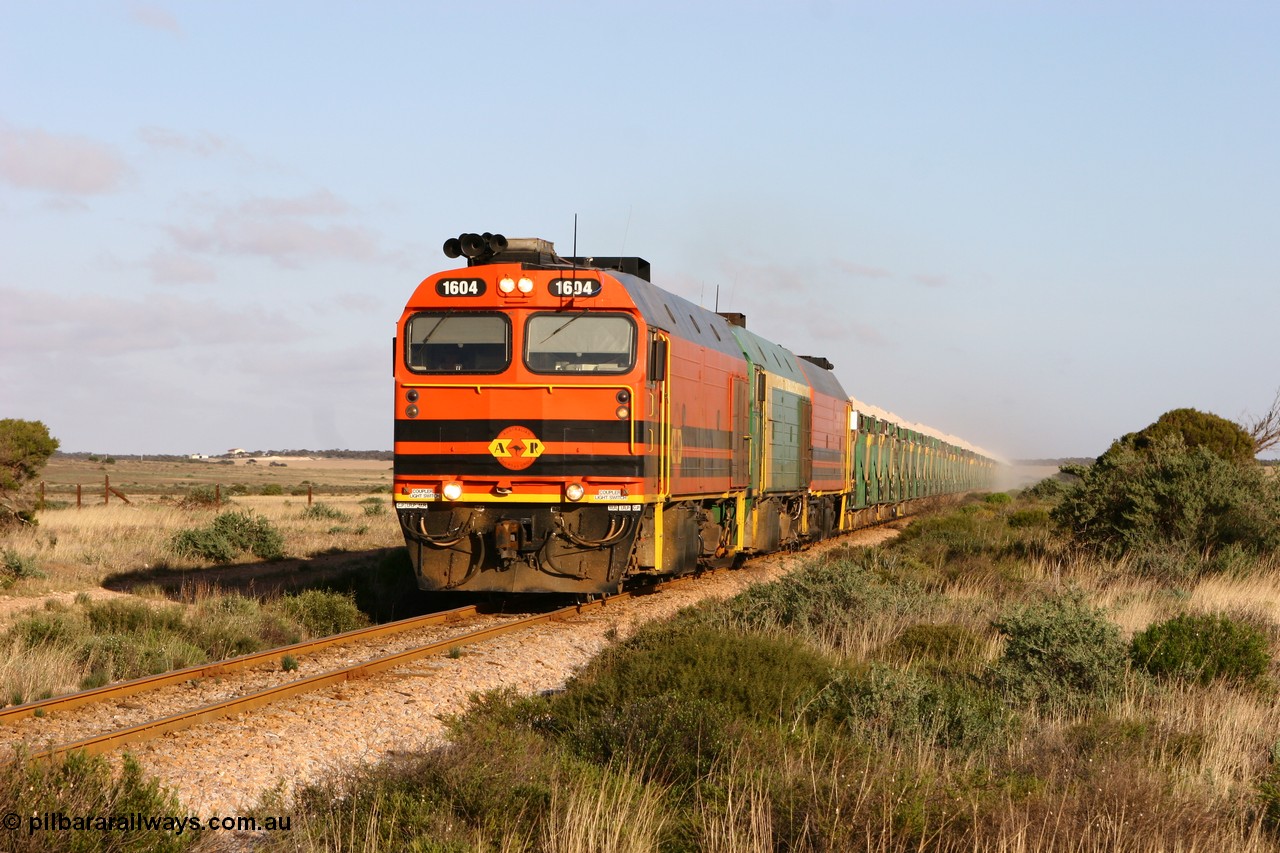 060113 2417
Ceduna, loaded gypsum train 6DD2 stirs up the dust behind the triple Clyde Engineering EMD JL22C model 1600 / NJ class combination of 1604 serial 71-731 and originally NJ 4, NJ 3 serial 71-730 and 1601 serial 71-728 class leader NJ 1, all three units started on the Central Australia Railway in 1971 and were transferred to the Eyre Peninsula in 1981. 08:10 AM on the Friday the 13th January 2006.
Keywords: 1600-class;1604;71-731;Clyde-Engineering-Granville-NSW;EMD;JL22C;NJ-class;NJ4;