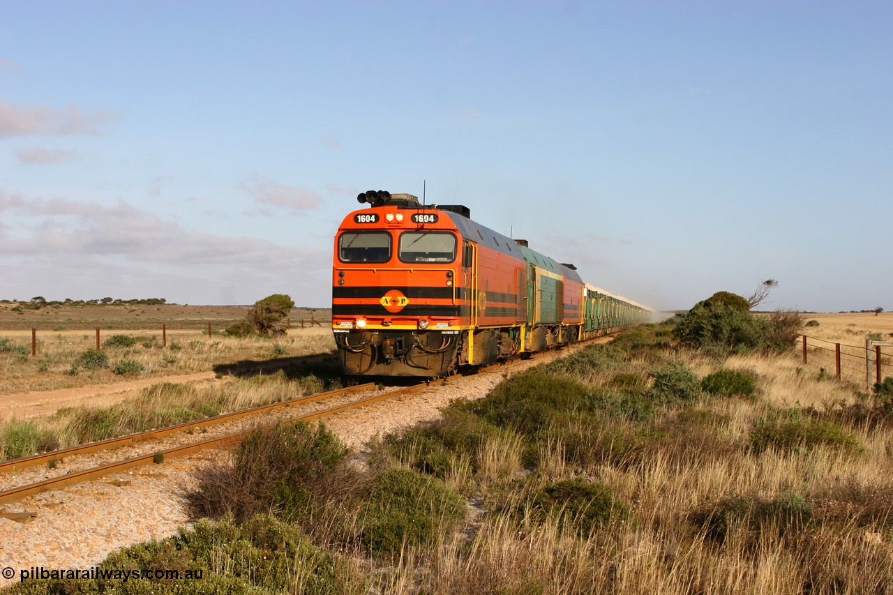 060113 2418
Ceduna, loaded gypsum train 6DD2 stirs up the dust behind the triple Clyde Engineering EMD JL22C model 1600 / NJ class combination of 1604 serial 71-731 and originally NJ 4, NJ 3 serial 71-730 and 1601 serial 71-728 class leader NJ 1, all three units started on the Central Australia Railway in 1971 and were transferred to the Eyre Peninsula in 1981. 08:10 AM on the Friday the 13th January 2006.
Keywords: 1600-class;1604;71-731;Clyde-Engineering-Granville-NSW;EMD;JL22C;NJ-class;NJ4;