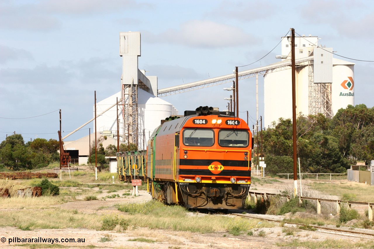 060113 2467
Thevenard, narrow gauge loco 1604 departs the yard with empty train 6DD3, 1604 leads a triple consist of Clyde Engineering built EMD JL22C model 1600 / NJ class combination of 1604 serial 71-731 and originally NJ 4, NJ 3 serial 71-730 and 1601 serial 71-728 the original class leader NJ 1, all three units started on the Central Australia Railway in 1971 and were transferred to the Eyre Peninsula in 1981. 1604 and 1601 both renumbered in 2004. 13th January 2006.
Keywords: 1600-class;1604;71-731;Clyde-Engineering-Granville-NSW;EMD;JL22C;NJ-class;NJ4;