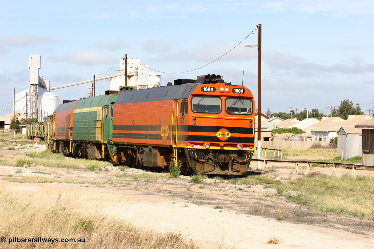 060113 2472
Thevenard, narrow gauge loco 1604 departs the yard with empty train 6DD3, 1604 leads a triple consist of Clyde Engineering built EMD JL22C model 1600 / NJ class combination of 1604 serial 71-731 and originally NJ 4, NJ 3 serial 71-730 and 1601 serial 71-728 the original class leader NJ 1, all three units started on the Central Australia Railway in 1971 and were transferred to the Eyre Peninsula in 1981. 1604 and 1601 both renumbered in 2004. 13th January 2006.
Keywords: 1600-class;1604;71-731;Clyde-Engineering-Granville-NSW;EMD;JL22C;NJ-class;NJ4;