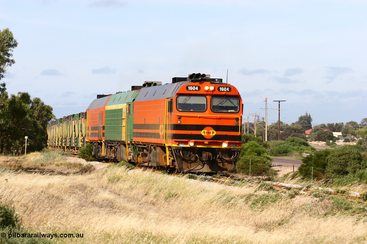 060113 2476
Thevenard, empty gypsum train 6DD3 lead by narrow gauge loco 1604 with a triple consist of Clyde Engineering built EMD JL22C model 1600 / NJ class combination of 1604 serial 71-731 and originally NJ 4, NJ 3 serial 71-730 and 1601 serial 71-728 the original class leader NJ 1, all three units started on the Central Australia Railway in 1971 and were transferred to the Eyre Peninsula in 1981. 1604 and 1601 both renumbered in 2004 [url=https://goo.gl/maps/3dLGGj7AFkE82J4A8]GeoData[/url]. 13th January 2006.
Keywords: 1600-class;1604;Clyde-Engineering-Granville-NSW;EMD;JL22C;71-731;NJ-class;NJ4;