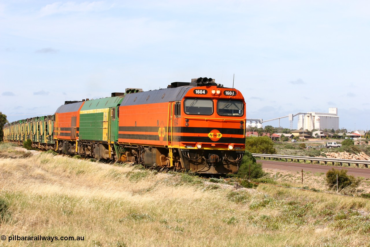 060113 2479
Thevenard, empty gypsum train 6DD3 lead by narrow gauge loco 1604 with a triple consist of Clyde Engineering built EMD JL22C model 1600 / NJ class combination of 1604 serial 71-731 and originally NJ 4, NJ 3 serial 71-730 and 1601 serial 71-728 the original class leader NJ 1, all three units started on the Central Australia Railway in 1971 and were transferred to the Eyre Peninsula in 1981. 1604 and 1601 both renumbered in 2004 [url=https://goo.gl/maps/3dLGGj7AFkE82J4A8]GeoData[/url]. 13th January 2006.
Keywords: 1600-class;1604;Clyde-Engineering-Granville-NSW;EMD;JL22C;71-731;NJ-class;NJ4;