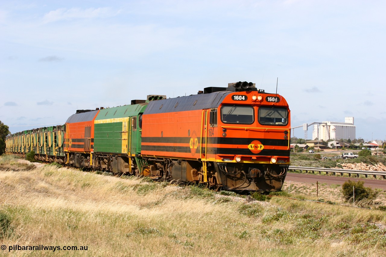 060113 2480
Thevenard, empty gypsum train 6DD3 lead by narrow gauge loco 1604 with a triple consist of Clyde Engineering built EMD JL22C model 1600 / NJ class combination of 1604 serial 71-731 and originally NJ 4, NJ 3 serial 71-730 and 1601 serial 71-728 the original class leader NJ 1, all three units started on the Central Australia Railway in 1971 and were transferred to the Eyre Peninsula in 1981. 1604 and 1601 both renumbered in 2004 [url=https://goo.gl/maps/3dLGGj7AFkE82J4A8]GeoData[/url]. 13th January 2006.
Keywords: 1600-class;1604;Clyde-Engineering-Granville-NSW;EMD;JL22C;71-731;NJ-class;NJ4;