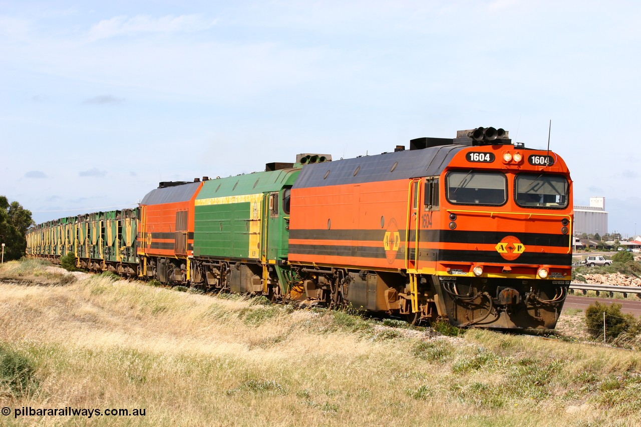 060113 2481
Thevenard, empty gypsum train 6DD3 lead by narrow gauge loco 1604 with a triple consist of Clyde Engineering built EMD JL22C model 1600 / NJ class combination of 1604 serial 71-731 and originally NJ 4, NJ 3 serial 71-730 and 1601 serial 71-728 the original class leader NJ 1, all three units started on the Central Australia Railway in 1971 and were transferred to the Eyre Peninsula in 1981. 1604 and 1601 both renumbered in 2004 [url=https://goo.gl/maps/3dLGGj7AFkE82J4A8]GeoData[/url]. 13th January 2006.
Keywords: 1600-class;1604;Clyde-Engineering-Granville-NSW;EMD;JL22C;71-731;NJ-class;NJ4;