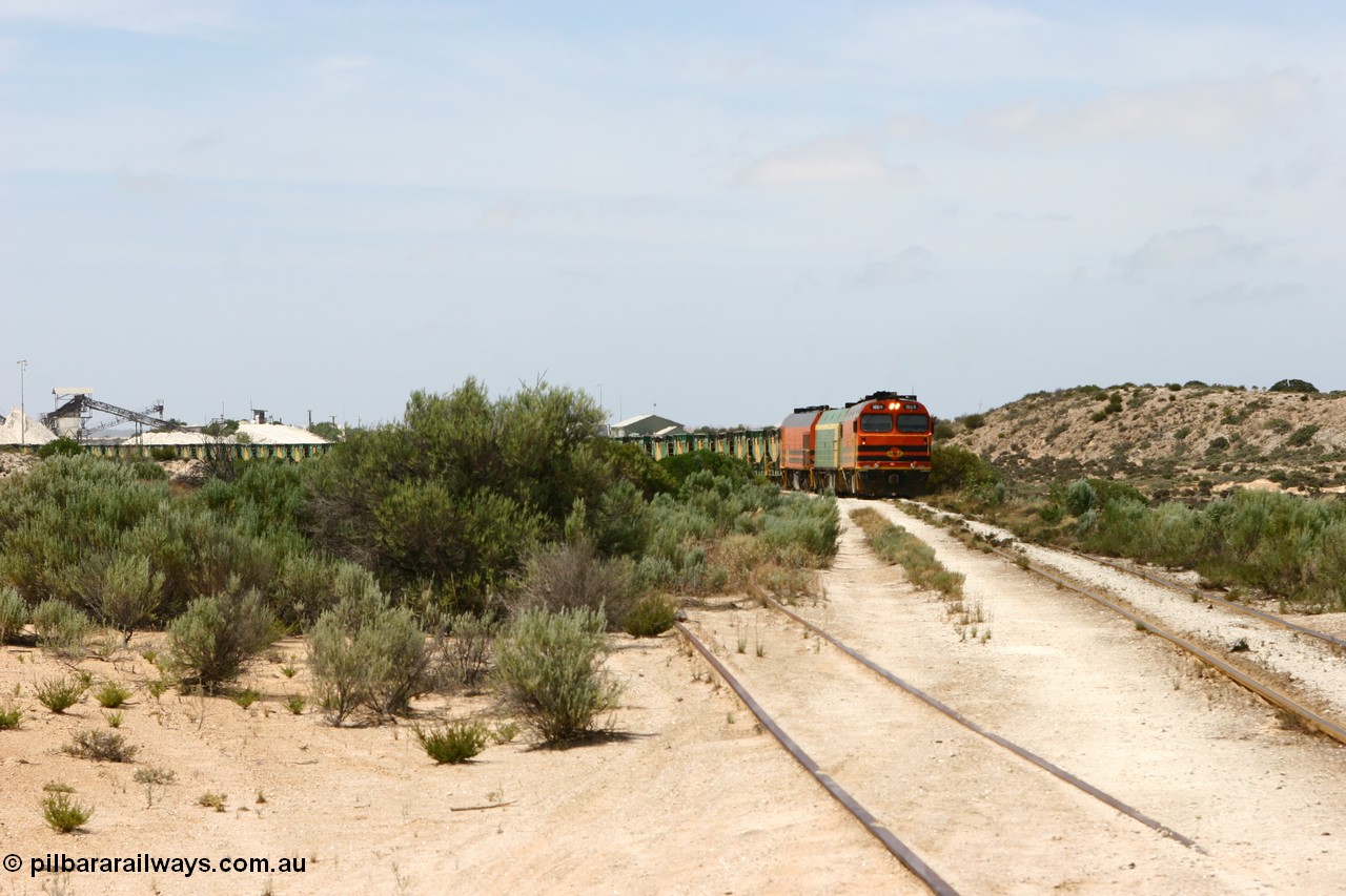 060113 2482
Thevenard, empty gypsum train 6DD3 lead by narrow gauge loco 1604 with a triple consist of Clyde Engineering built EMD JL22C model 1600 / NJ class combination of 1604 serial 71-731 and originally NJ 4, NJ 3 serial 71-730 and 1601 serial 71-728 the original class leader NJ 1, all three units started on the Central Australia Railway in 1971 and were transferred to the Eyre Peninsula in 1981. 1604 and 1601 both renumbered in 2004 [url=https://goo.gl/maps/3dLGGj7AFkE82J4A8]GeoData[/url]. 13th January 2006.
Keywords: 1600-class;1604;Clyde-Engineering-Granville-NSW;EMD;JL22C;71-731;NJ-class;NJ4;