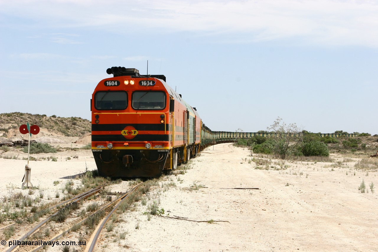 060113 2539
Kevin, 1600 class unit 1604 in Australian Railroad Group livery a Clyde Engineering built EMD JL22C model serial 71-731, originally built as NJ class NJ 4 and built for the Central Australia Railway in 1971, transferred to the Eyre Peninsula in 1981, shunts back along the Penong line with the points indicator set for the siding and the goods siding on the right of the train. [url=https://goo.gl/maps/JyRQW]Kevin station area[/url], as the train is reversed prior to loading on the mainline to Thevenard. 13th January 2006.
Keywords: 1600-class;1604;Clyde-Engineering-Granville-NSW;EMD;JL22C;71-731;NJ-class;NJ4;