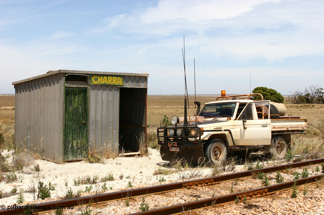 060113 2556
Charra at the 466.2 km, [url=https://goo.gl/maps/GpLTsHYeUymGtK5f7]Mallee style shelter building[/url]. Opened with the line on 13th February 1966 as a goods siding, reclassified as passing siding and extended, new goods loop siding constructed May 1982. 13th January 2006.

