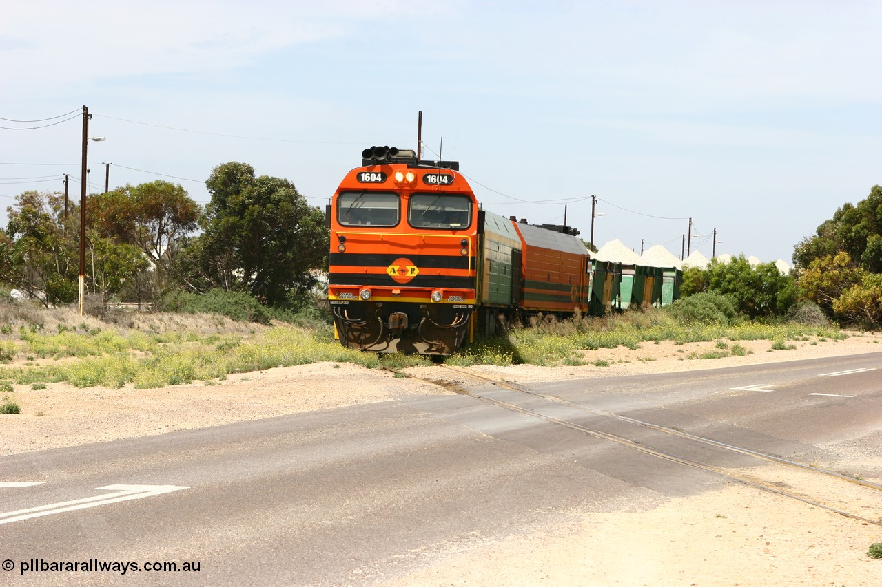 060113 2561
Thevenard, loaded gypsum train 6DD4 snakes through the yard as it is about to cross Bergmann Drive behind 1600 class unit 1604 in Australian Railroad Group livery a Clyde Engineering built EMD JL22C model serial 71-731, originally built as NJ class NJ 4. [url=https://goo.gl/maps/9g3QoE4iaiDjqyta9]Bergmann Dr grade crossing[/url]. 13th January 2006.
Keywords: 1600-class;1604;71-731;Clyde-Engineering-Granville-NSW;EMD;JL22C;NJ-class;NJ4;