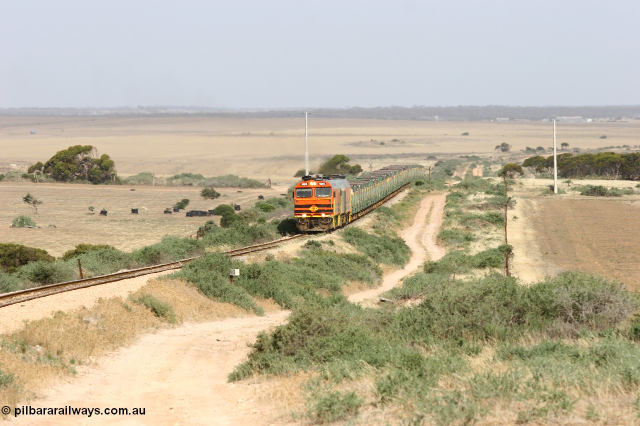 060113 2572
Ceduna, or Denial Bay area, empty gypsum train 6DD5 blasts up hill at the 440 km, crossing Carpenter Corner Rd with power from triple 1600/NJ class units 1604, NJ 3 and 1601. 1604 in Australian Railroad Group livery is a Clyde Engineering built EMD JL22C model serial 71-731, originally built as NJ class NJ 4. [url=https://goo.gl/maps/ULA2PjjKh6nhwHTdA]Location approximation[/url]. 13th January 2006.
Keywords: 1600-class;1604;71-731;Clyde-Engineering-Granville-NSW;EMD;JL22C;NJ-class;NJ4;