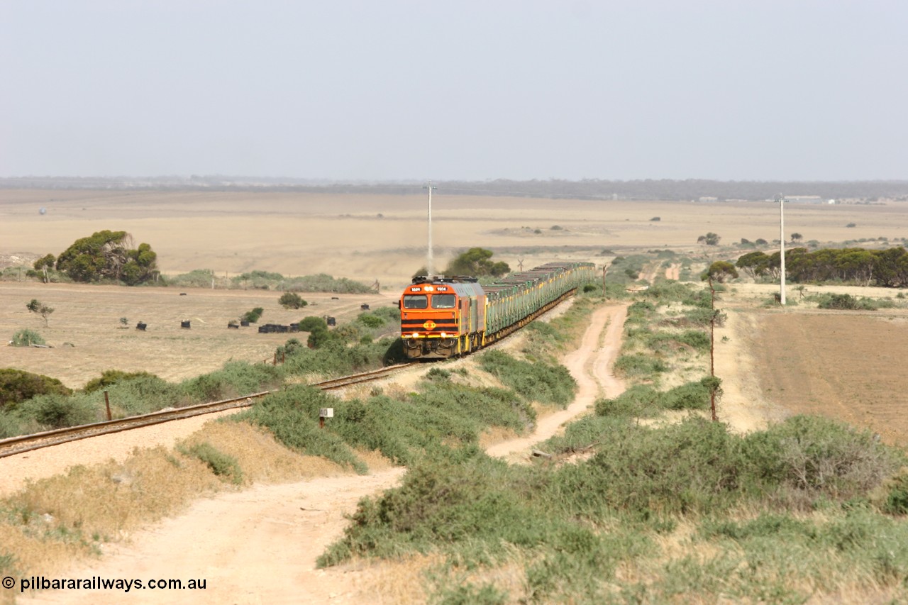 060113 2573
Ceduna, or Denial Bay area, empty gypsum train 6DD5 blasts up hill at the 440 km, crossing Carpenter Corner Rd with power from triple 1600/NJ class units 1604, NJ 3 and 1601. 1604 in Australian Railroad Group livery is a Clyde Engineering built EMD JL22C model serial 71-731, originally built as NJ class NJ 4. [url=https://goo.gl/maps/ULA2PjjKh6nhwHTdA]Location approximation[/url]. 13th January 2006.
Keywords: 1600-class;1604;71-731;Clyde-Engineering-Granville-NSW;EMD;JL22C;NJ-class;NJ4;