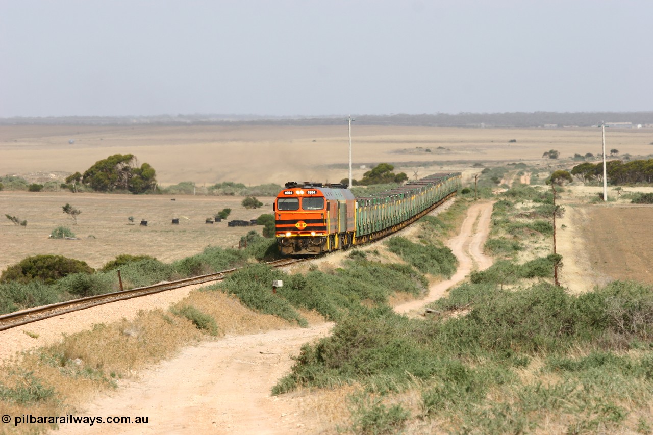 060113 2575
Ceduna, or Denial Bay area, empty gypsum train 6DD5 blasts up hill at the 440 km, crossing Carpenter Corner Rd with power from triple 1600/NJ class units 1604, NJ 3 and 1601. 1604 in Australian Railroad Group livery is a Clyde Engineering built EMD JL22C model serial 71-731, originally built as NJ class NJ 4. [url=https://goo.gl/maps/ULA2PjjKh6nhwHTdA]Location approximation[/url]. 13th January 2006.
Keywords: 1600-class;1604;71-731;Clyde-Engineering-Granville-NSW;EMD;JL22C;NJ-class;NJ4;