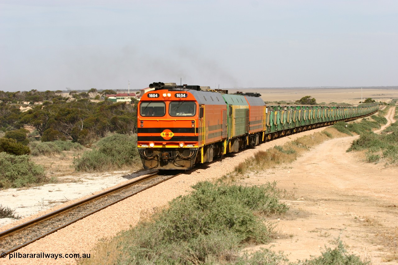 060113 2582
Ceduna, or Denial Bay area, empty gypsum train 6DD5 blasts up hill at the 440 km, west of Carpenter Corner Rd with power from triple 1600/NJ class units 1604, NJ 3 and 1601. 1604 in Australian Railroad Group livery is a Clyde Engineering built EMD JL22C model serial 71-731, originally built as NJ class NJ 4. [url=https://goo.gl/maps/ULA2PjjKh6nhwHTdA]Location approximation[/url]. 13th January 2006.
Keywords: 1600-class;1604;Clyde-Engineering-Granville-NSW;EMD;JL22C;71-731;NJ-class;NJ4;