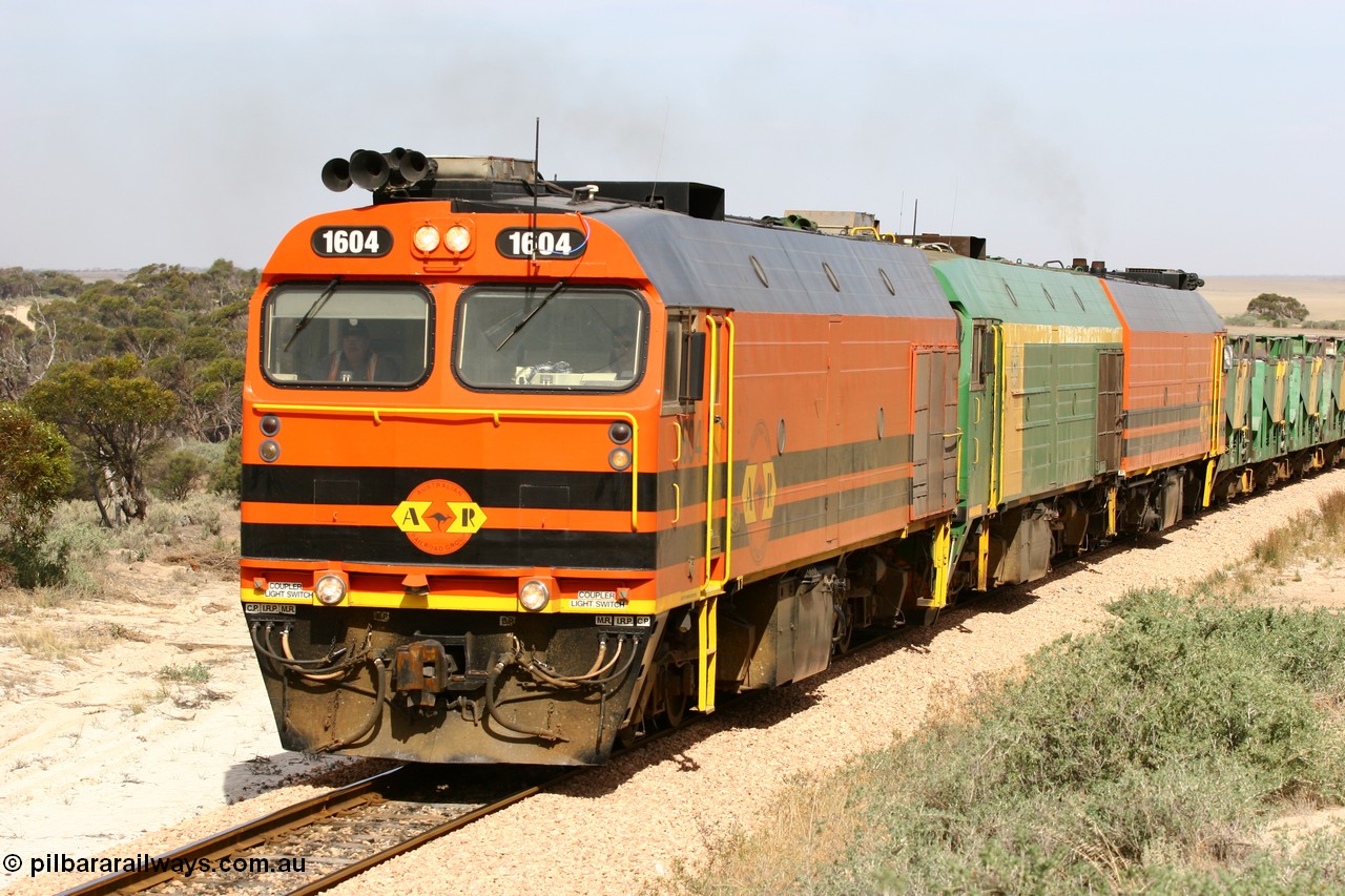 060113 2585
Ceduna, or Denial Bay area, empty gypsum train 6DD5 blasts up hill at the 440 km, west of Carpenter Corner Rd with power from triple 1600/NJ class units 1604, NJ 3 and 1601. 1604 in Australian Railroad Group livery is a Clyde Engineering built EMD JL22C model serial 71-731, originally built as NJ class NJ 4. [url=https://goo.gl/maps/ULA2PjjKh6nhwHTdA]Location approximation[/url]. 13th January 2006.
Keywords: 1600-class;1604;Clyde-Engineering-Granville-NSW;EMD;JL22C;71-731;NJ-class;NJ4;