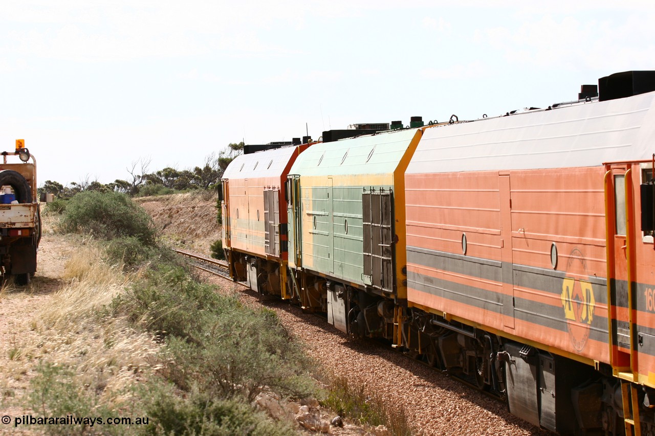 060113 2586
Ceduna, or Denial Bay area, empty gypsum train 6DD5 blasts up hill at the 440 km, west of Carpenter Corner Rd with power from triple 1600/NJ class units 1604, NJ 3 and 1601. 1601 in Australian Railroad Group livery is a Clyde Engineering built EMD JL22C model serial 71-728, originally built as NJ class NJ 1. [url=https://goo.gl/maps/ULA2PjjKh6nhwHTdA]Location approximation[/url]. 13th January 2006.
Keywords: 1600-class;1601;Clyde-Engineering-Granville-NSW;EMD;JL22C;71-728;NJ-class;NJ1;