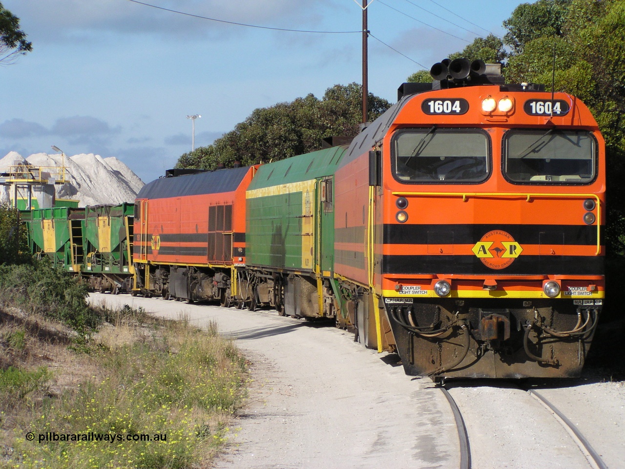 060113 P1010169
Thevenard, at the gypsum unloading site, 1604 leads a triple consist of Clyde Engineering EMD JL22C model 1600 / NJ class combination of 1604 serial 71-731 and originally NJ 4, NJ 3 serial 71-730 and 1601 serial 71-728 class leader NJ 1, all three units started on the Central Australia Railway in 1971 and were transferred to the Eyre Peninsula in 1981. 1604 and 1601 both renumbered in 2004. Friday 13th January 2006. Pope Searle photo.
Keywords: 1600-class;1604;Clyde-Engineering-Granville-NSW;EMD;JL22C;71-731;NJ-class;NJ4;