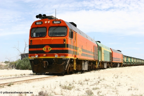 060113 2546
Kevin, narrow gauge locos 1604, NJ 3 and 1601 take the mainline to Thevenard, having reversed train 6DD3 on the Kevin triangle as they prepare to load, 1600 class unit 1604 in Australian Railroad Group livery a Clyde Engineering built EMD JL22C model serial 71-731, originally built as NJ class NJ 4 and built for the Central Australia Railway in 1971, transferred to the Eyre Peninsula in 1981. January 13, 2006.
Keywords: 1600-class;1604;Clyde-Engineering-Granville-NSW;EMD;JL22C;71-731;NJ-class;NJ4;