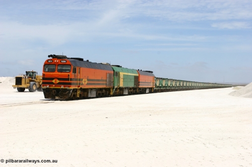060113 2549
Kevin, standing on the mainline to Thevenard, and the train now identified as 6DD4 has commenced loading of gypsum but the 988 Cat front end loaders which takes about one and half hours to load. As the train reversed on the triangle the consist is the same heading back loaded with 1604 leading NJ 3 and 1601. January 13, 2006.
Keywords: 1600-class;1604;Clyde-Engineering-Granville-NSW;EMD;JL22C;71-731;NJ-class;NJ4;