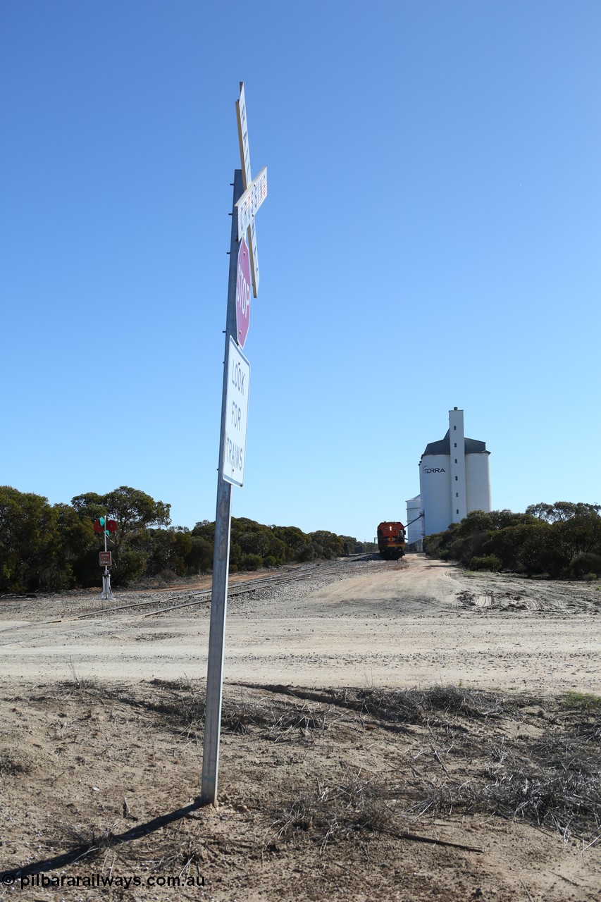 130703 0160
Murdinga, overview of the station yard looking north, siding point lever and indicator, Mallee style shelter train control building in the far distance on the left beside train, grain train loading on the siding, eight cell concrete grain silo complex with Ascom single cell behind it. [url=https://goo.gl/maps/LShPNnU33Qbmc1879]Geo location[/url]. 3rd July 2013.
