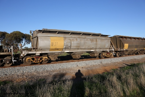 130703 0273
Kaldow, HCN type bogie grain hopper waggon HCN 12, originally an NHB type hopper built by Tulloch Ltd for the Commonwealth Railways North Australia Railway. One of forty rebuilt by Islington Workshops 1978-79 to the HCN type with a 36 ton rating, increased to 40 tonnes in 1984. Seen here loaded with grain with a Moose Metalworks roll-top cover. [url=https://goo.gl/maps/bG8SzxeWzL1eSEWUA]Geo location[/url]. July 3, 2006.
Keywords: HCN-type;HCN12;SAR-Islington-WS;rebuild;Tulloch-Ltd-NSW;NHB-type;NHB1591;