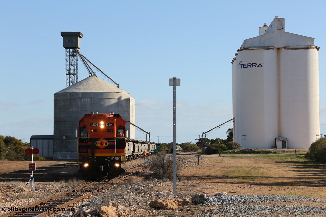 130704 0371
Kyancutta, south bound loaded grain train has stopped here to collect a loaded rack of fourteen grain waggons from the Ascom silo complex, Clyde Engineering built EMD G12C model 1204 serial 65-428 leads the train and was originally built in 1965 for Western Mining Corporation and operated by the WAGR as their A class A 1514.
Keywords: 1200-class;1204;Clyde-Engineering-Granville-NSW;EMD;G12C;65-428;A-class;A1514;