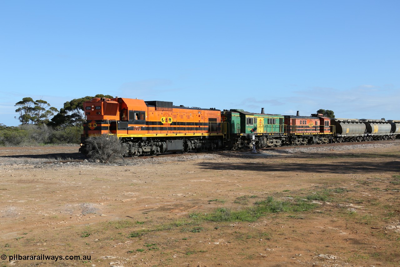 130704 0373
Kyancutta, south bound loaded grain train has stopped here to collect a loaded rack of fourteen grain waggons from the Ascom silo complex, Clyde Engineering built EMD G12C model 1204 serial 65-428 leads the train and was originally built in 1965 for Western Mining Corporation and operated by the WAGR as their A class A 1514.
Keywords: 1200-class;1204;Clyde-Engineering-Granville-NSW;EMD;G12C;65-428;A-class;A1514;