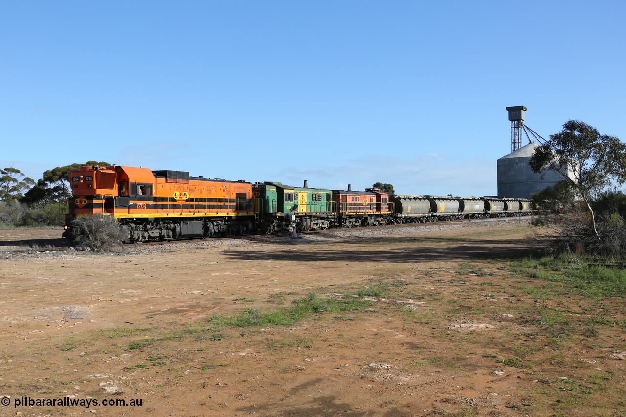 130704 0374
Kyancutta, south bound loaded grain train has stopped here to collect a loaded rack of fourteen grain waggons from the Ascom silo complex, Clyde Engineering built EMD G12C model 1204 serial 65-428 leads the train and was originally built in 1965 for Western Mining Corporation and operated by the WAGR as their A class A 1514.
Keywords: 1200-class;1204;Clyde-Engineering-Granville-NSW;EMD;G12C;65-428;A-class;A1514;