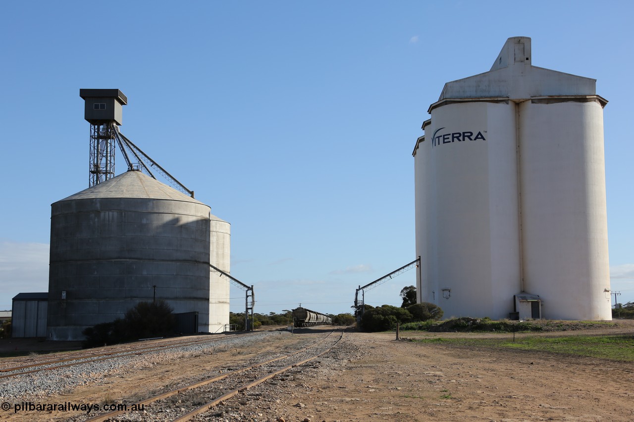 130704 0405
Kyancutta, yard overview looking north with the Ascom silo complex of the left, Mallee shelter visible in the shadow, the 'new' grain loop added in 1970, mainline with loaded grain waggons, the original good siding and the concrete eight cell silo complex. 4th July 2013.
