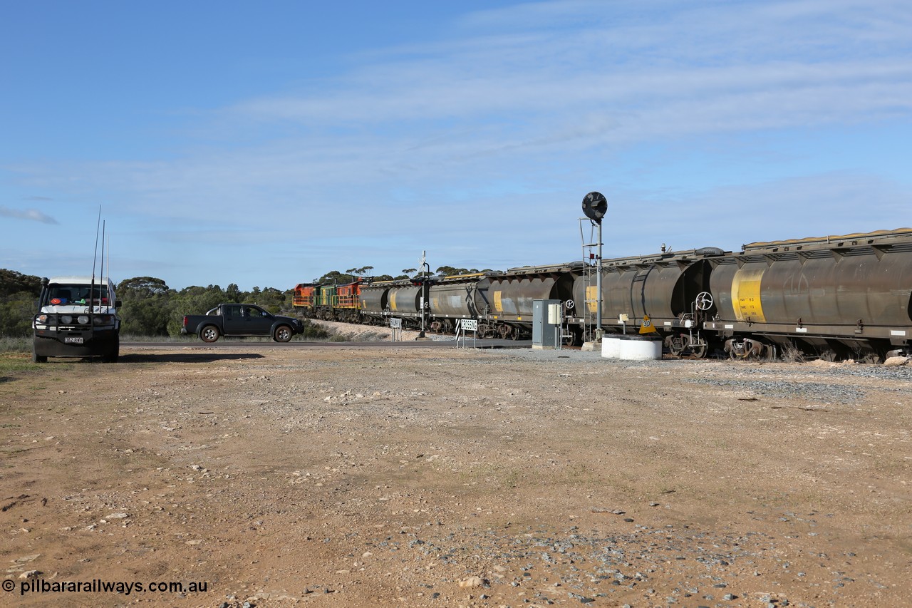130704 0411
Kyancutta, south bound loaded grain train has stopped here to collect a loaded rack of grain waggons, seen here backing up to re-join the rest of the train on the mainline as it crosses the Eyre Highway grade crossing and one of only three electric signals on the network, behind EMD 1204 and twin ALCo 830 units 873 and 851. 4th July 2013.
