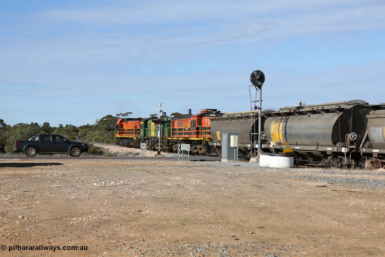 130704 0413
Kyancutta, south bound loaded grain train has stopped here to collect a loaded rack of grain waggons, seen here backing up to re-join the rest of the train on the mainline as it crosses the Eyre Highway grade crossing and one of only three electric signals on the network, behind EMD 1204 and twin ALCo 830 units 873 and 851. 4th July 2013.
