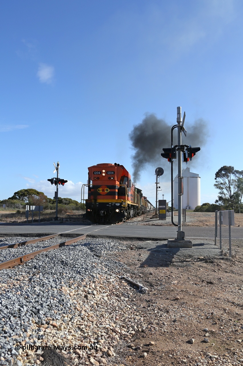 130704 0444
Kyancutta, the south bound loaded grain train gets away from attaching a further fourteen loads here as it is about to cross the Eyre Highway grade crossing with F Type flashing lights. 4th July 2013.
Keywords: 1200-class;1204;Clyde-Engineering-Granville-NSW;EMD;G12C;65-428;A-class;A1514;