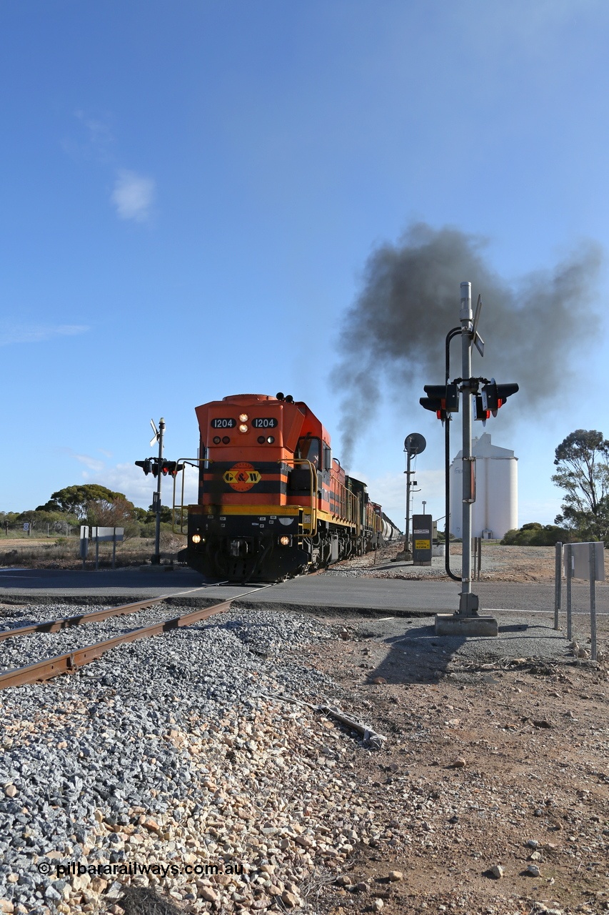 130704 0445
Kyancutta, the south bound loaded grain train gets away from attaching a further fourteen loads here as it crosses the Eyre Highway grade crossing with F Type flashing lights behind 1200 class EMD unit 1204. 4th July 2013.
Keywords: 1200-class;1204;Clyde-Engineering-Granville-NSW;EMD;G12C;65-428;A-class;A1514;