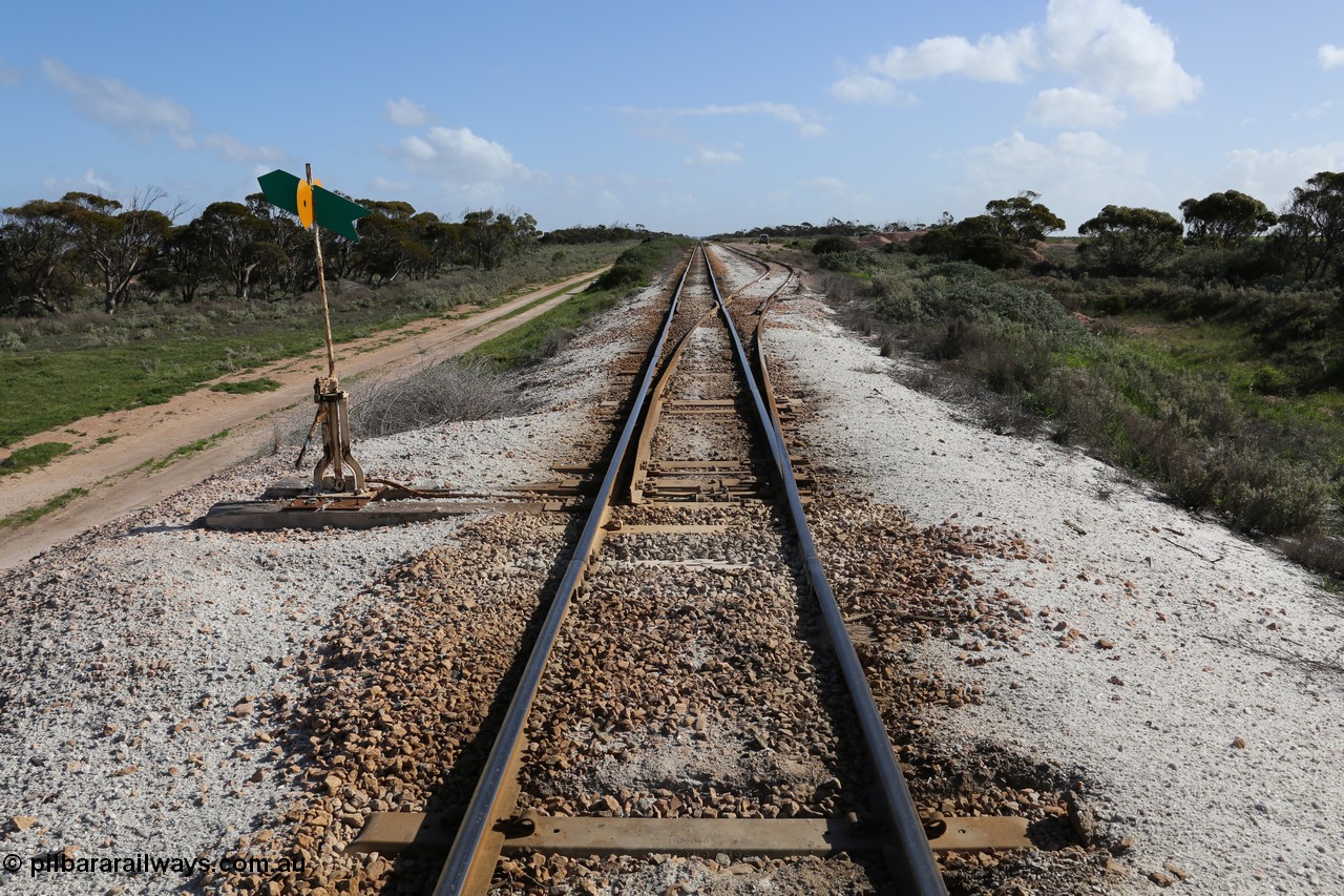 130704 0503
Moule, yard overview looking west from the east end points of the crossing loop, Moule located at the 445.6 km was opened in February 1966 when the Direct Line between Ceduna and Kevin was opened. From the left point lever and indicator, the crossing loop on the right and then the ballast pile in the distance. [url=https://goo.gl/maps/XvLsRfFyxbnmjHzq7]Location is here[/url]. 4th July 2013.
