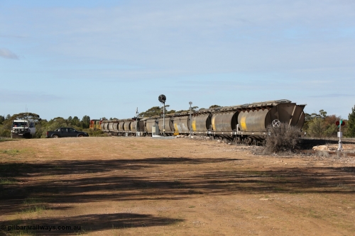 130704 0406
Kyancutta, south bound loaded grain train has stopped here to collect a loaded rack of grain waggons, seen here waiting for the points to be restored for the mainline across the Eyre Highway grade crossing and one of only three electric signals on the network, behind EMD 1204 and twin ALCo 830 units 873 and 851. July 4, 2006.
