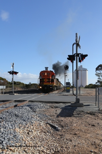 130704 0442
Kyancutta, the south bound loaded grain train gets away from attaching a further fourteen loads here as it is about to cross the Eyre Highway grade crossing with F Type flashing lights. July 4, 2006.
Keywords: 1200-class;1204;Clyde-Engineering-Granville-NSW;EMD;G12C;65-428;A-class;A1514;