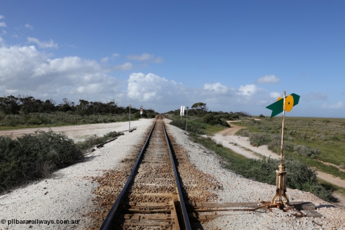 130704 0505
Moule, view looking east from the eastern end of the crossing loop with the point lever and indicator. The small 30 sign is the speed limit, the grade crossing is to access the ballast stockpile area. July 4, 2006.
