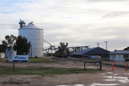130705 0603
Lock, located at the 148.5 km and originally named Terre when opened in May 1913, later renamed to Lock in December 1921. From the left is the concrete toilet block, Ascom silo complex (Block 5), the train is loading on the grain loop, loaded rake on the mainline, horizontal bunker (Block 4) and the crew barracks. July 5, 2013.
