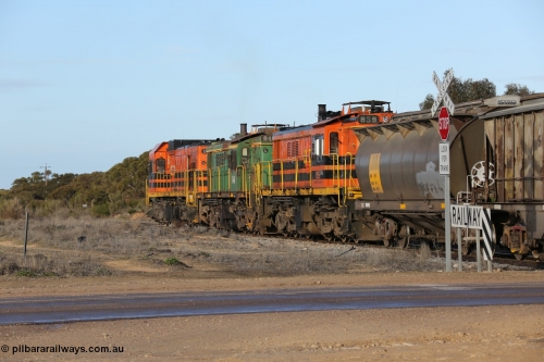 130705 0627
Lock, with loading finished, 1203 leads 846, 859 and the final portion out along the mainline out of goods siding #1 across Birdseye Hwy as it prepares to shunt back onto the loaded portion on the mainline for departure to Port Lincoln.
