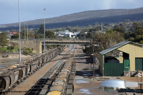 130706 0673
Port Lincoln, looking in the down direction from the London Street overbridge at the yard environs with the AN Freight Shed now museum on the right. The sign next to the point indicator states the Depot is Unattended. July 6, 2013.
